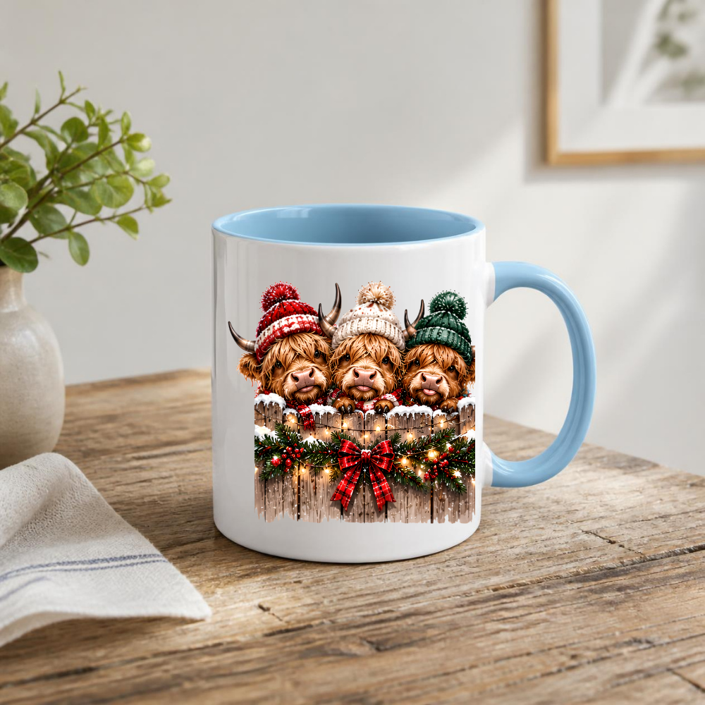 Highland Cows Christmas Fence Mug "Merry & Bright" Festive Highland Cows 325ml Ceramic Coffee Mug – Three Cute Cows in Winter Bobble Hats Behind Snowy Fence with Fairy Lights & Red Tartan Bow | Christmas Gift | Fast Dispatch by UK Seller (M3429)