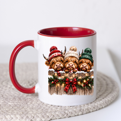 Highland Cows Christmas Fence Mug "Merry & Bright" Festive Highland Cows 325ml Ceramic Coffee Mug – Three Cute Cows in Winter Bobble Hats Behind Snowy Fence with Fairy Lights & Red Tartan Bow | Christmas Gift | Fast Dispatch by UK Seller (M3429)