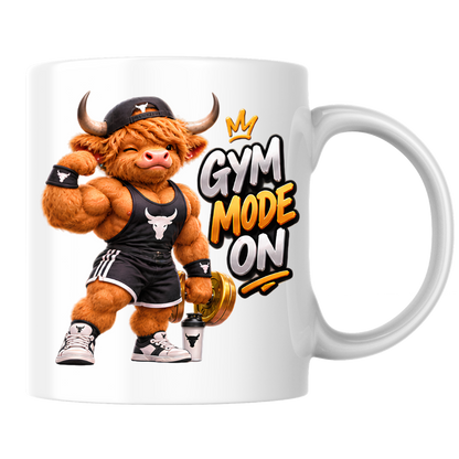Gym Mug "Gym Mode ON Muscular Highland Cow" Gym Mode ON 325ml Ceramic Coffee Mug – Muscular Winking Highland Cow in Tank Top & Cap Flexing Bicep Holding Gold Dumbbell Shaker Gym Fitness Gift | Available in Multicolours | Fast Dispatch by UK Seller (M3271)