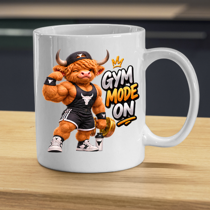 Gym Mug "Gym Mode ON Muscular Highland Cow" Gym Mode ON 325ml Ceramic Coffee Mug – Muscular Winking Highland Cow in Tank Top & Cap Flexing Bicep Holding Gold Dumbbell Shaker Gym Fitness Gift | Available in Multicolours | Fast Dispatch by UK Seller (M3271)