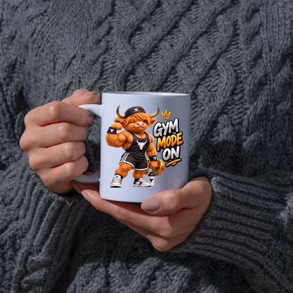 Gym Mug "Gym Mode ON Muscular Highland Cow" Gym Mode ON 325ml Ceramic Coffee Mug – Muscular Winking Highland Cow in Tank Top & Cap Flexing Bicep Holding Gold Dumbbell Shaker Gym Fitness Gift | Available in Multicolours | Fast Dispatch by UK Seller (M3271)