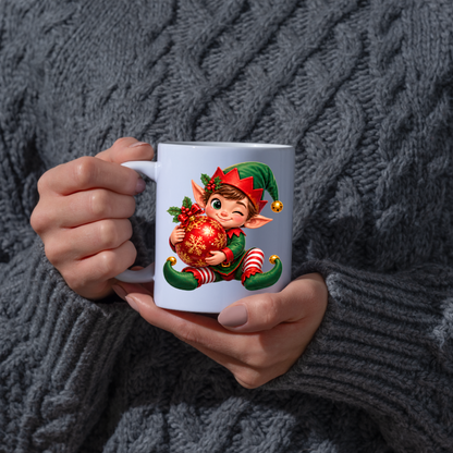 Christmas Mug "Winking Christmas Boy Elf Red Bauble" Winking Christmas Boy Elf 325ml Ceramic Coffee Mug – Cute Festive Tea Cup with Elf Outfit Jingle Bells Snowflake Bauble Graphic Gift | Available in Multicolours | Fast Dispatch by UK Seller (M3186)
