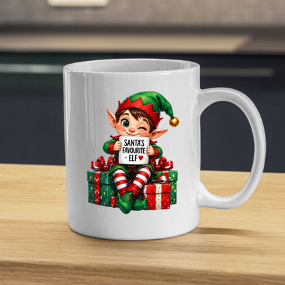 Festive Mug "Santa's Favourite Elf" Christmas Holiday Character 325ml Ceramic Coffee Mug – Cute Holiday Tea Cup with Elf Hat & Gift Box Sign | Available in Multicolours | Fast Dispatch by UK Seller (M1242)