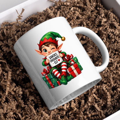 Festive Mug "Santa's Favourite Elf" Christmas Holiday Character 325ml Ceramic Coffee Mug – Cute Holiday Tea Cup with Elf Hat & Gift Box Sign | Available in Multicolours | Fast Dispatch by UK Seller (M1242)