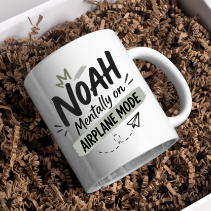 Personalized Name Mug "Noah Mentally On Airplane Mode" Noah Mentally On Airplane Mode 325ml Ceramic Coffee Mug – Custom Name Typography Slogan with Crown, Grey Brushstroke Banner & Paper Plane Graphic | Funny Gift | Fast Dispatch by UK Seller (M3453)