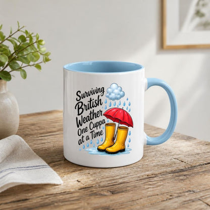 Humorous Mug "Surviving British Weather One Cuppa at a Time" 325ml Ceramic Coffee Mug Funny Rainy Day Tea Cup with Yellow Wellies, Red Umbrella & Raindrops Graphic Gift | Available in Multicolours | Fast Dispatch by UK Seller (M1318)