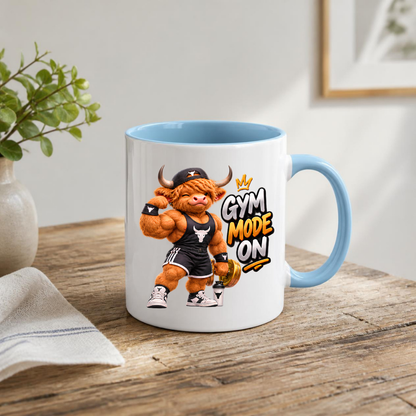 Gym Mug "Gym Mode ON Muscular Highland Cow" Gym Mode ON 325ml Ceramic Coffee Mug – Muscular Winking Highland Cow in Tank Top & Cap Flexing Bicep Holding Gold Dumbbell Shaker Gym Fitness Gift | Available in Multicolours | Fast Dispatch by UK Seller (M3271)