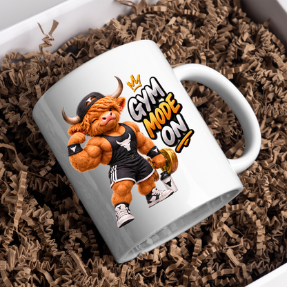 Gym Mug "Gym Mode ON Muscular Highland Cow" Gym Mode ON 325ml Ceramic Coffee Mug – Muscular Winking Highland Cow in Tank Top & Cap Flexing Bicep Holding Gold Dumbbell Shaker Gym Fitness Gift | Available in Multicolours | Fast Dispatch by UK Seller (M3271)